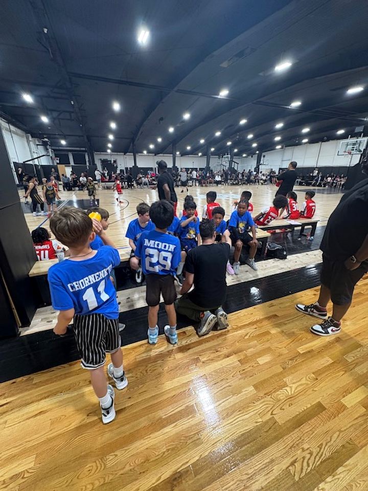 North City Bruins players and coaches on the sideline during their first basketball weekend