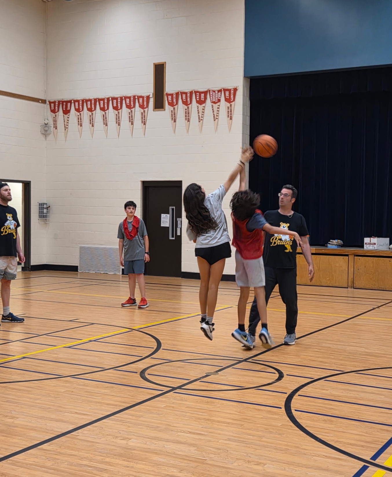North City Bruins players competing for the basketball during a drill