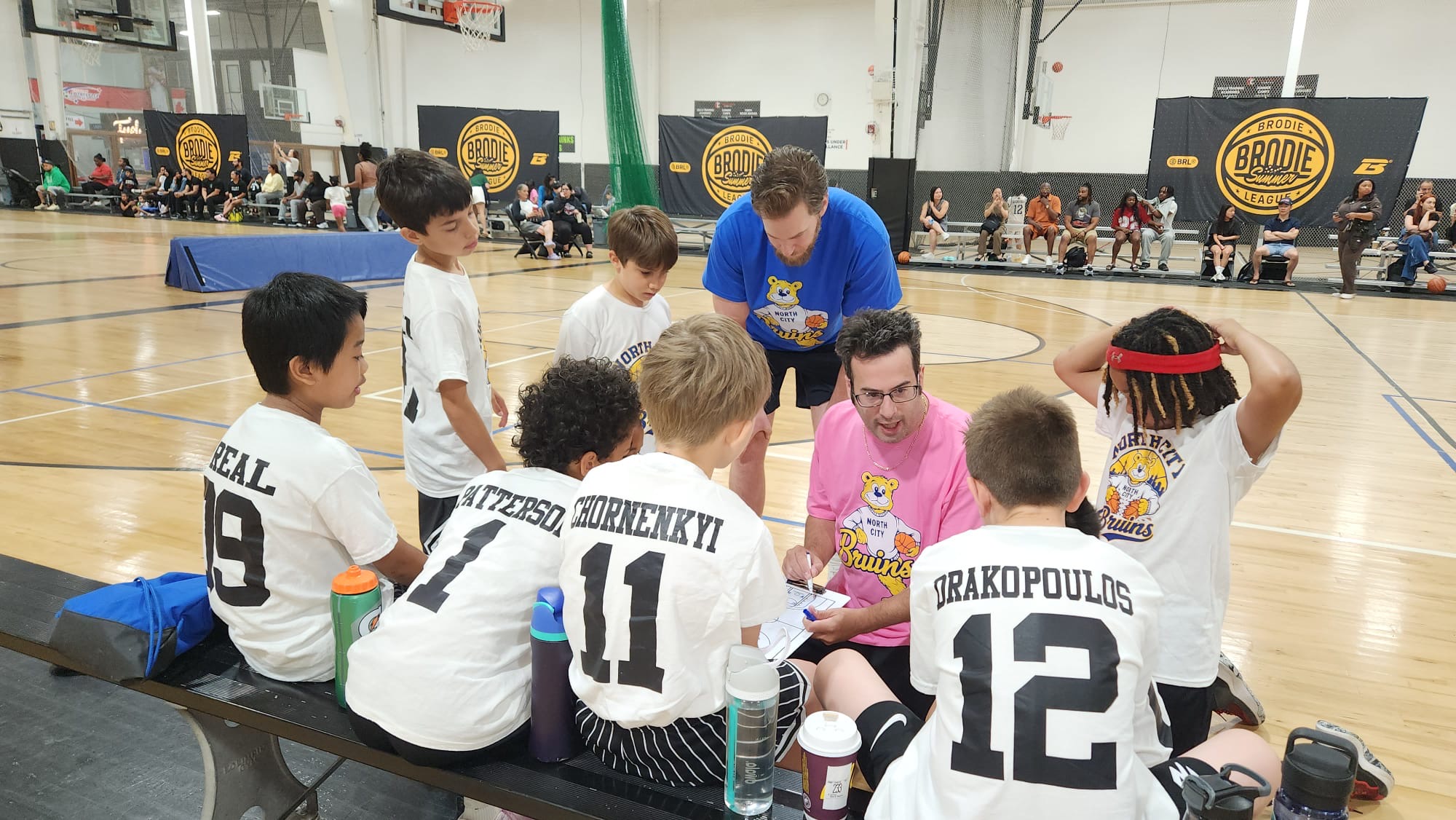 North City Bruins coach speaking with players during a team huddle